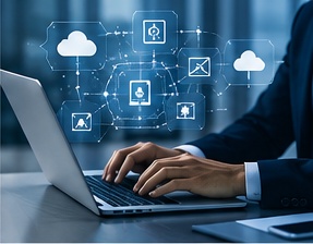 Professional typing on a laptop with cloud and data icons above