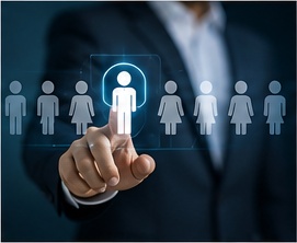 Hand selecting a highlighted figure from a row of people icons